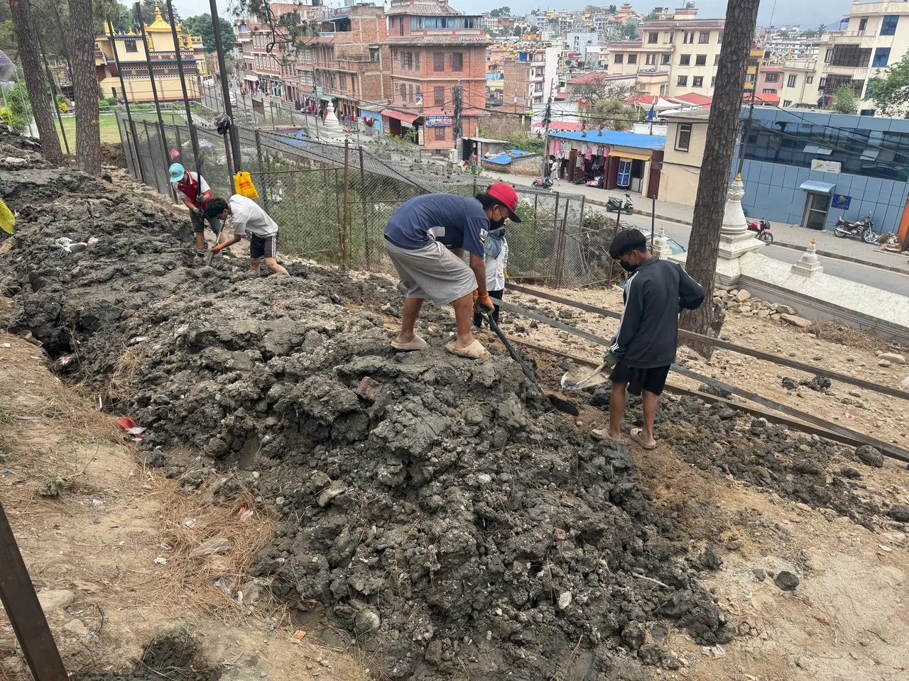 Spreading a delivery of topsoil to address soil erosion